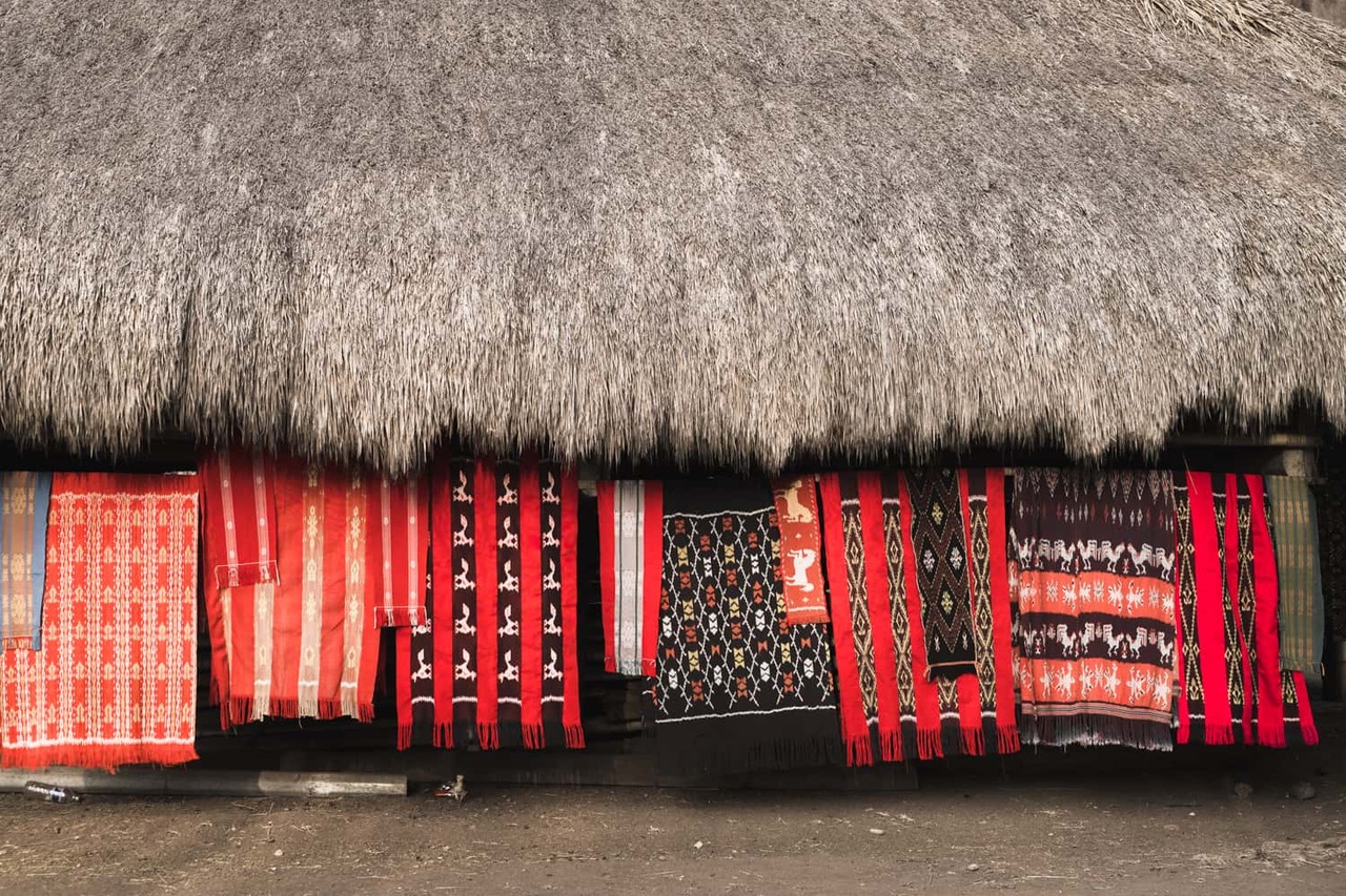 Red Ikat hanging in front of traditional house