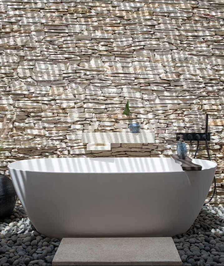 Garden Suite Openair bathtub with bespore ceramics and white stone wall